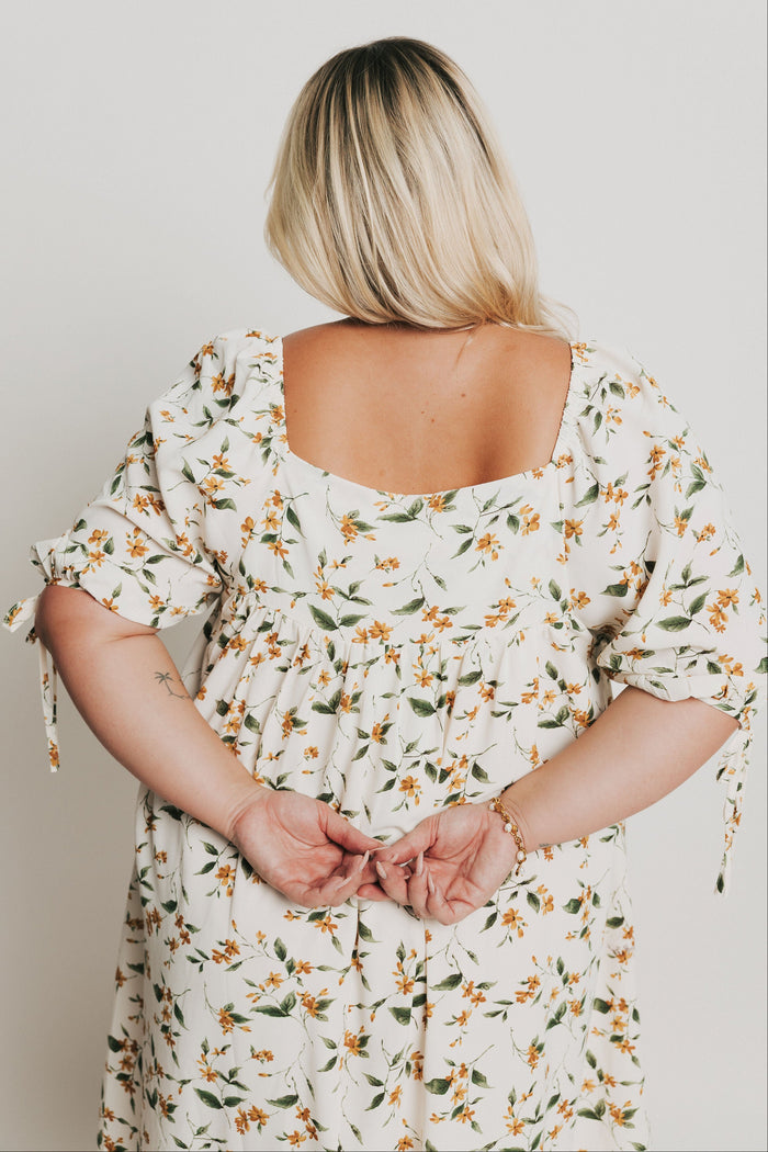 knee length floral dress with square neck and puff sleeves back