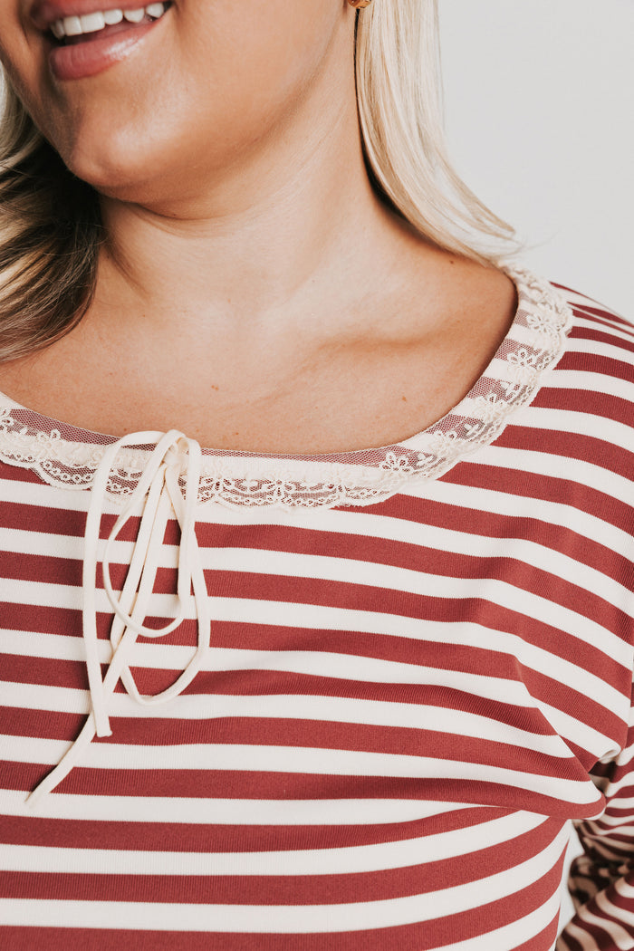 burgundy striped top with lace trim on neckline and sleeves close