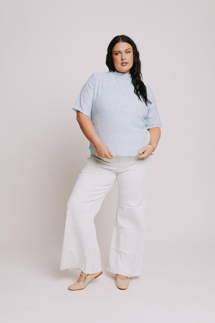 light blue top with textured pattern and mock neck full