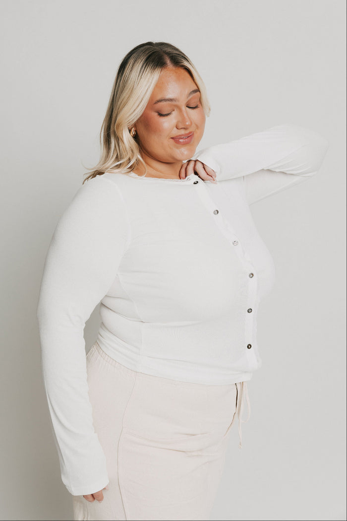 white long sleeve top with buttons and lace trim on neckline side