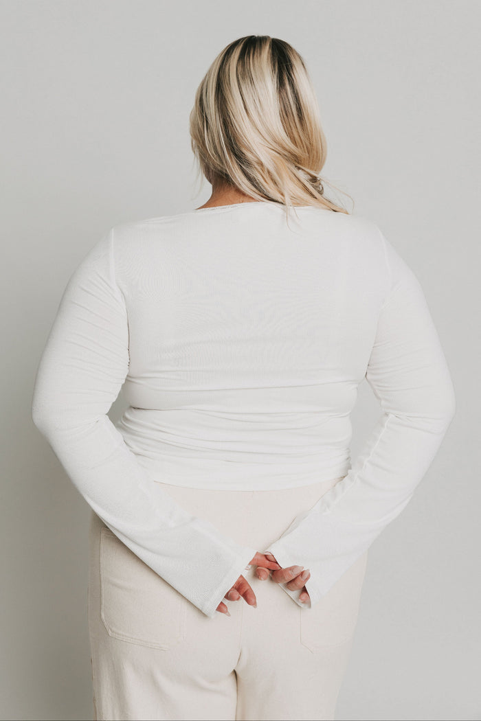 white long sleeve top with buttons and lace trim on neckline back