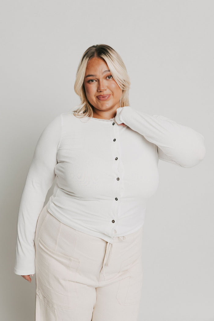 white long sleeve top with buttons and lace trim on neckline full