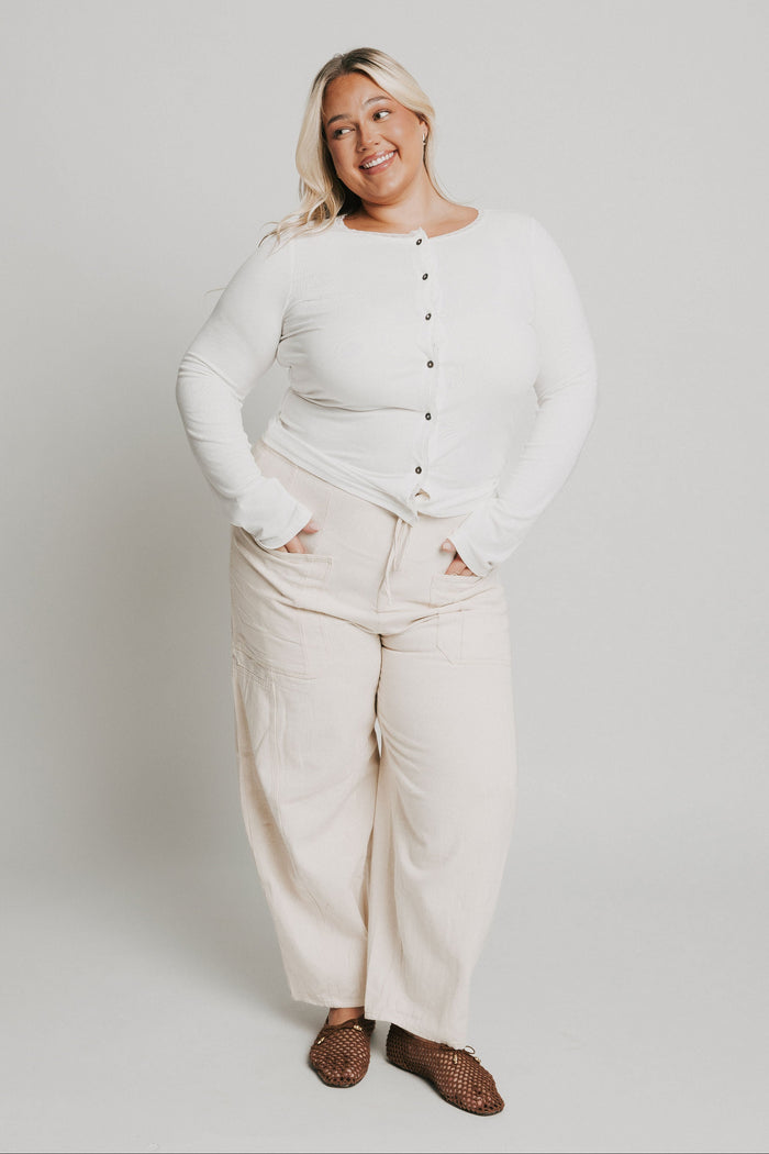 white long sleeve top with buttons and lace trim on neckline