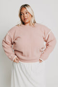 pink crewneck sweater with white trim