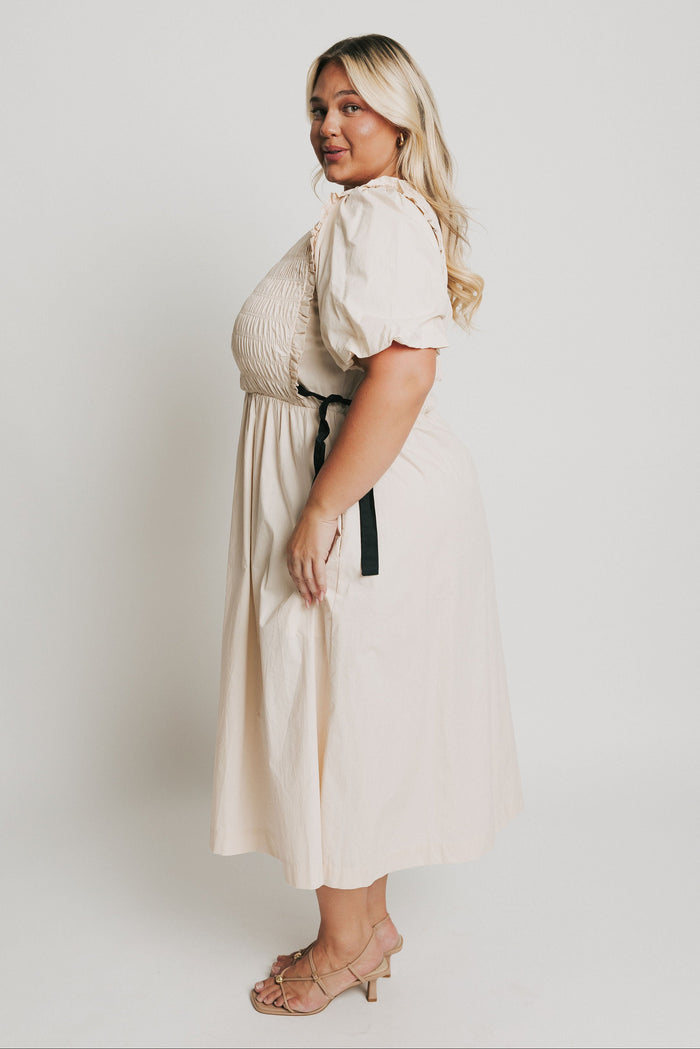 cream midi dress with black bow accents side