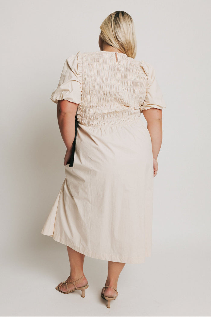 cream midi dress with black bow accents back