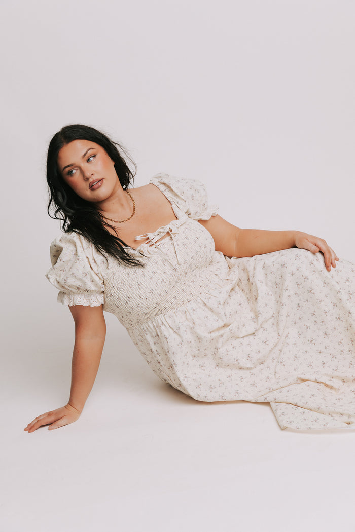 ivory floral dress with lace up detail and eyelet trim plus pose