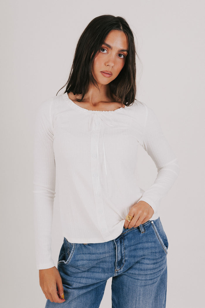 white long sleeve top with lace detail and bow