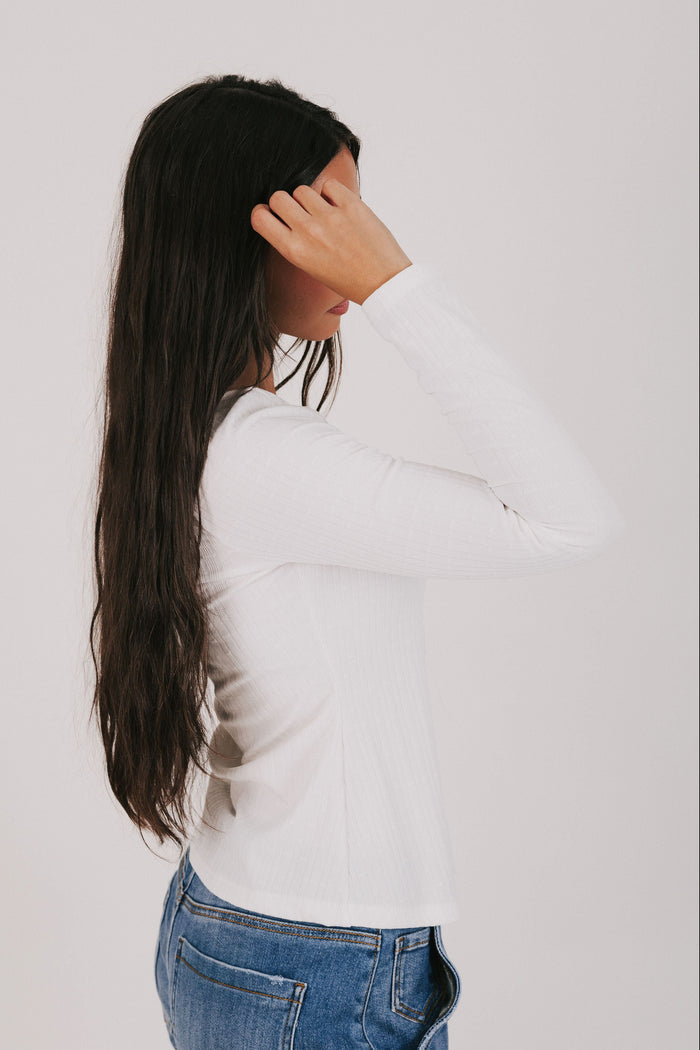 white long sleeve top with lace detail and bow
