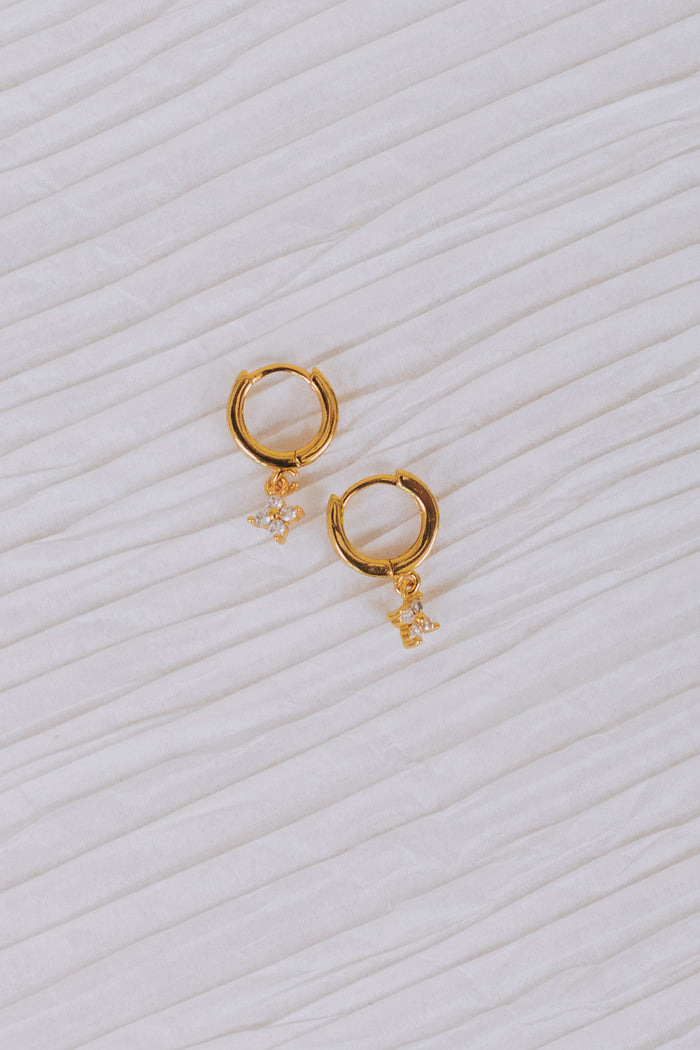 gold hoop earring with huggie closure and faux diamond clover flower dangle