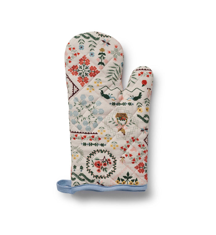 Decorative oven mitt with floral and geometric patterns on a white background