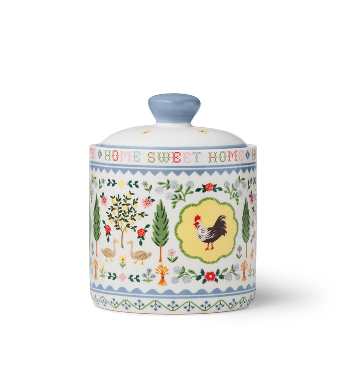 Decorative ceramic jar with chicken design and 'Home Sweet Home' text on a white background