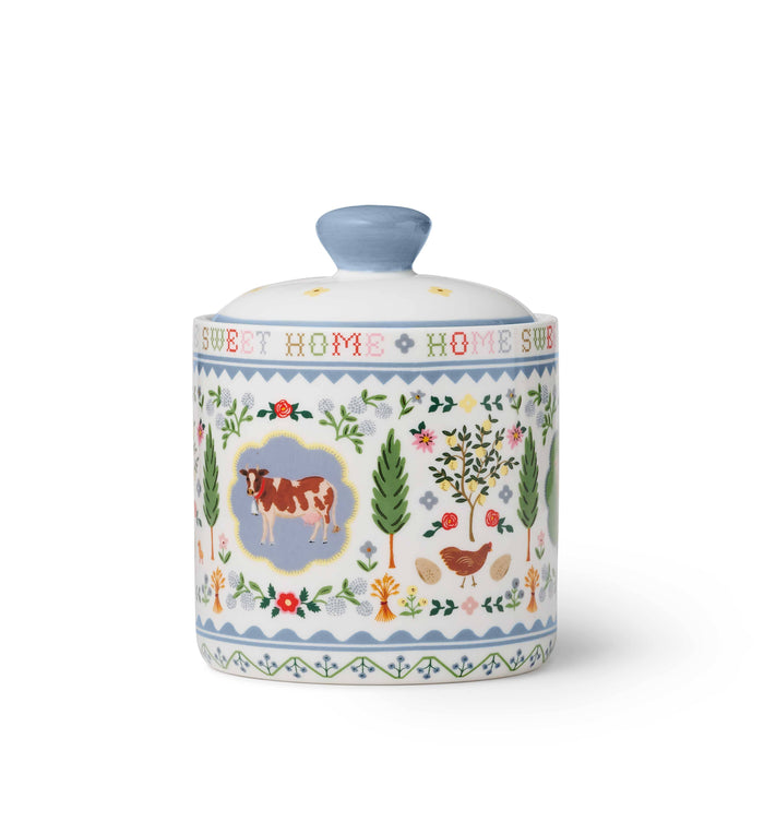Decorative ceramic jar with farm animal illustrations and 'Sweet Home' text on a white background