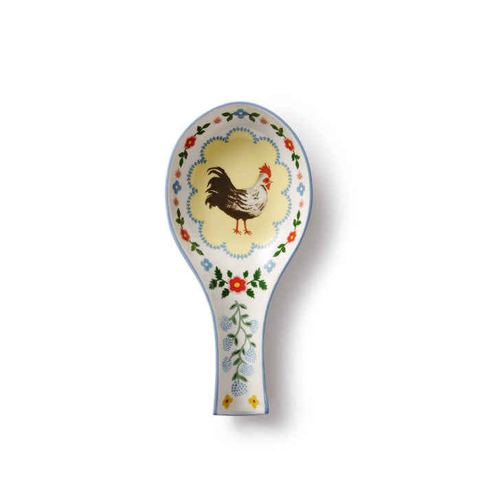 Decorative spoon rest with rooster design on a white background
