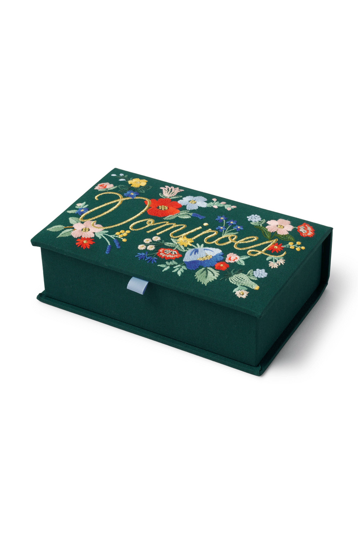 set of dominoes in a floral embroidered box.
