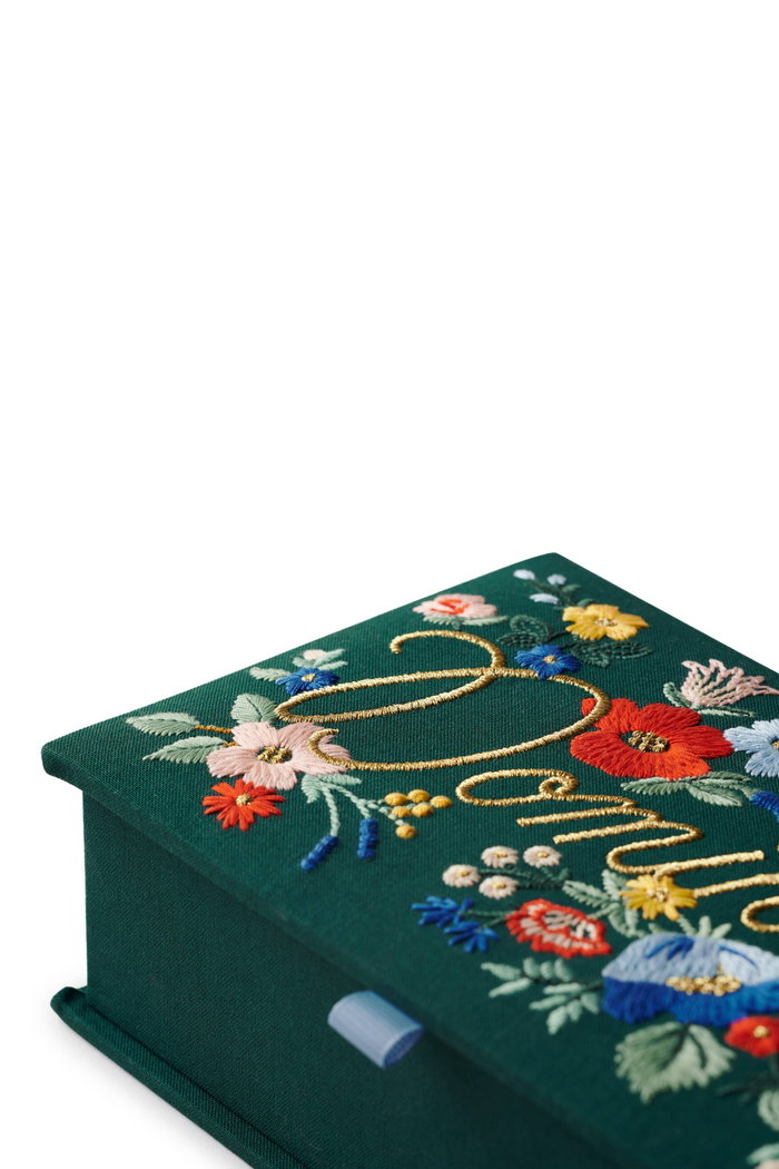 Closeup of embroidery on dominoes box.