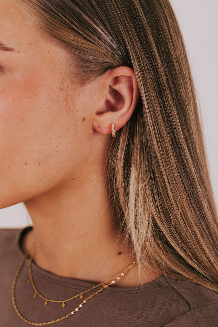 gold hoop huggie earring with cubic zirconia details