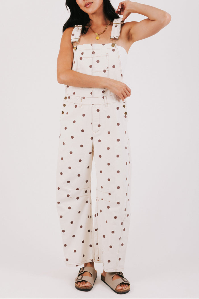 cream overalls with brown polka dots