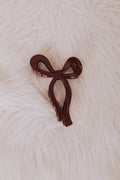 burgundy plastic bow hair clip flatlay