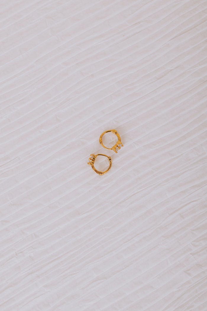 cubic zirconia floral huggie earrings flatlay 2