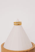 Gold ring with asymmetrical pearl line