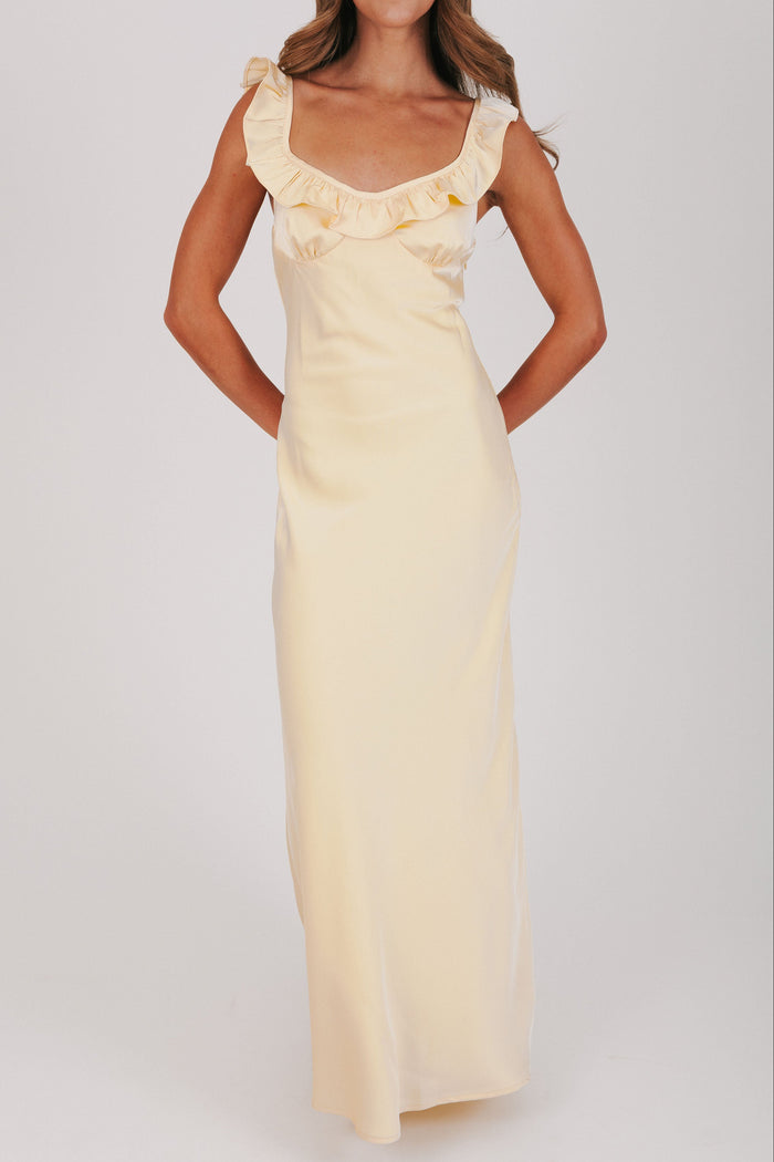 yellow satin dress with ruffle trim on neckline