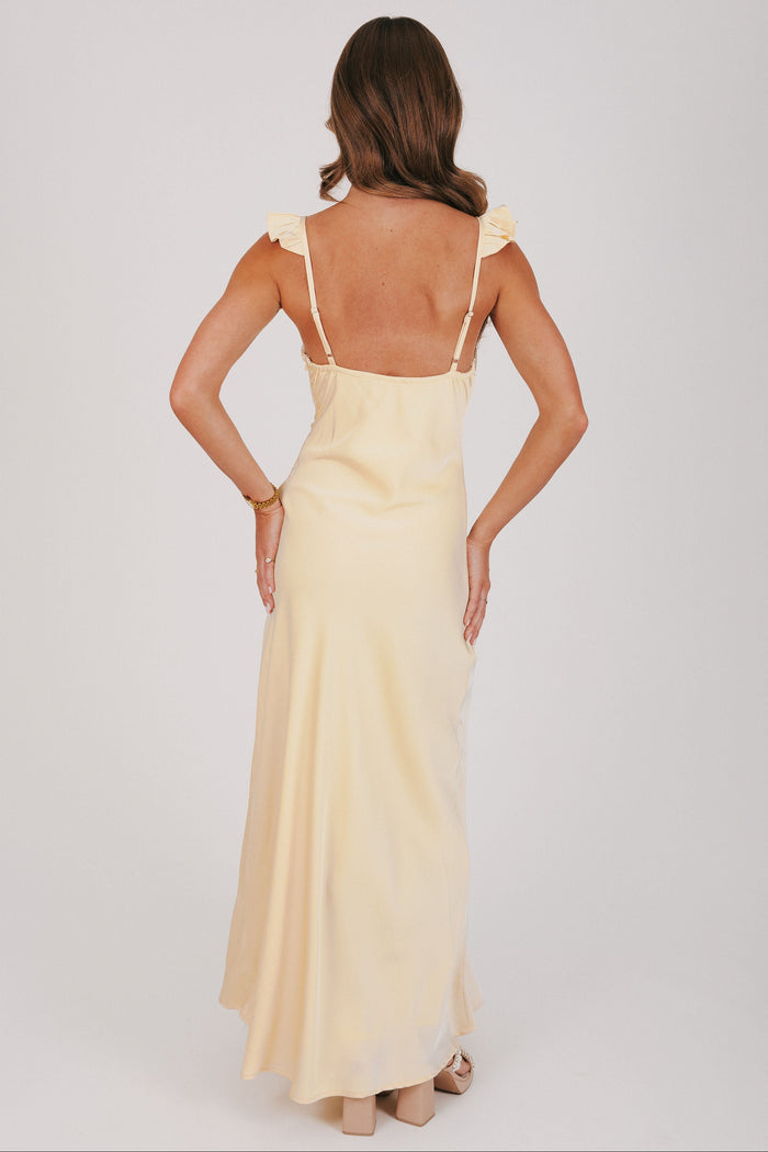 yellow satin dress with ruffle trim on neckline back