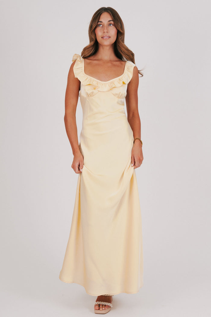 yellow satin dress with ruffle trim on neckline full