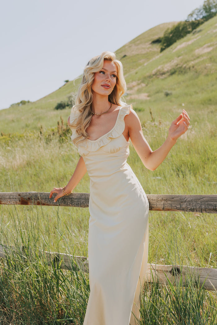 yellow satin dress with ruffle trim on neckline lifestyle