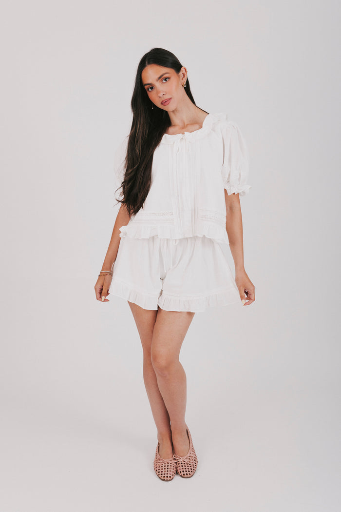 White top and shorts set with a puff sleeve blouse and elastic waistband shorts