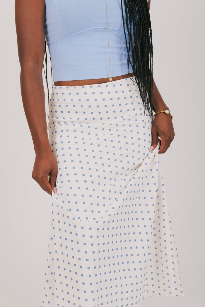 white skirt with blue polka dots