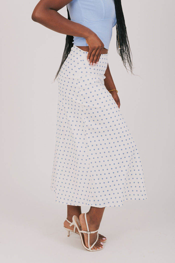 white skirt with blue polka dots