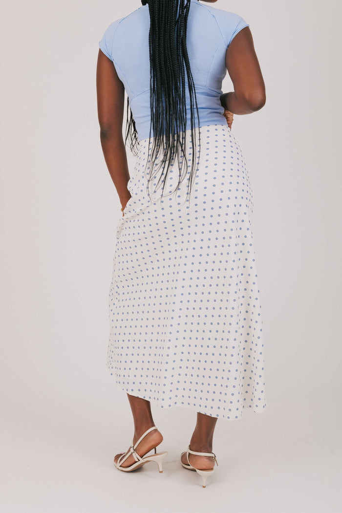 white skirt with blue polka dots
