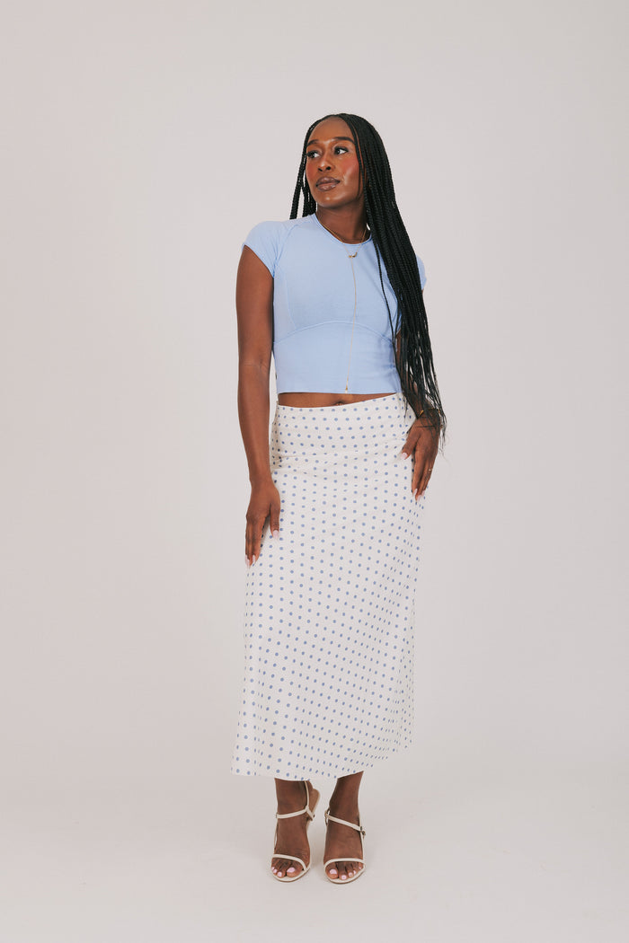 white skirt with blue polka dots