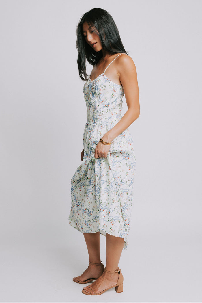 white spaghetti strap midi dress with blue bow pattern side