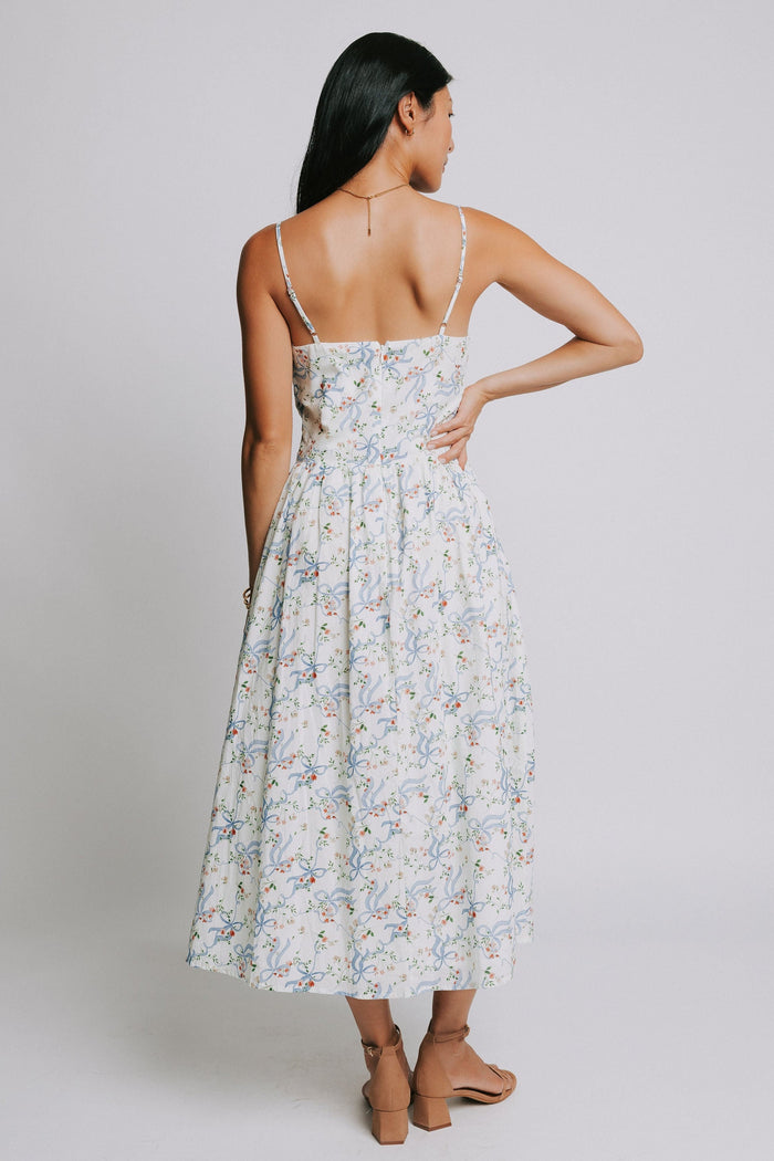 white spaghetti strap midi dress with blue bow pattern back
