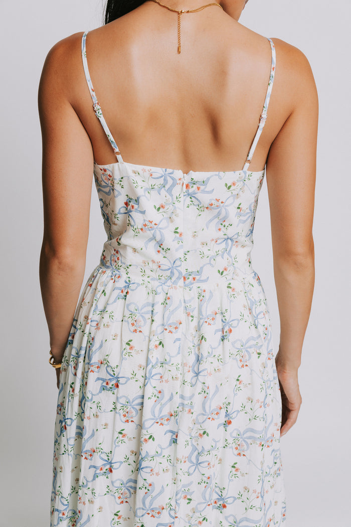 white spaghetti strap midi dress with blue bow pattern back close