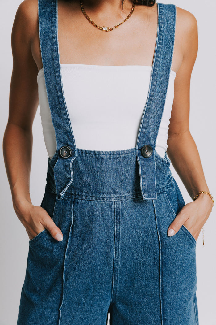 denim suspender jumpsuit with seamed detailing close