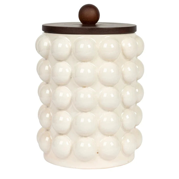 White textured jar with a wooden lid on a white background