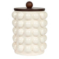 White textured jar with a wooden lid on a white background