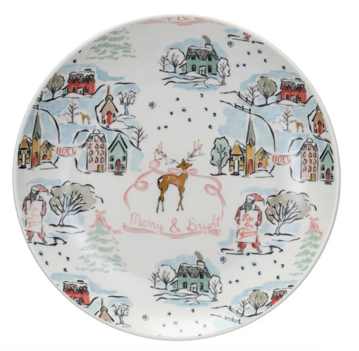 Decorative plate with winter scene design featuring houses, trees, and people with 'Merry & Bright' text.