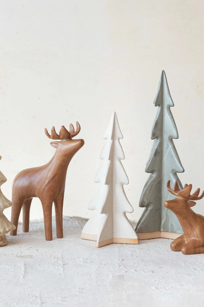 White cream stoneware ceramic decorative tree posed with similar decorations.