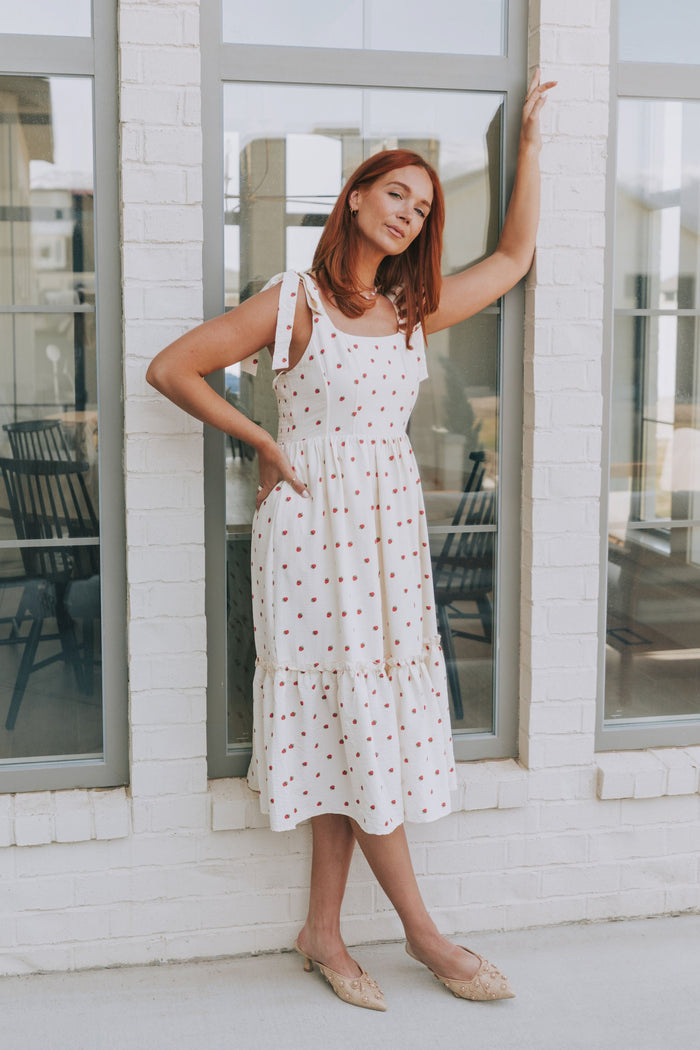 cream midi dress with strawberry print and bows on shoulders