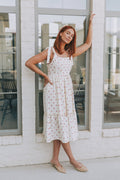 cream midi dress with strawberry print and bows on shoulders