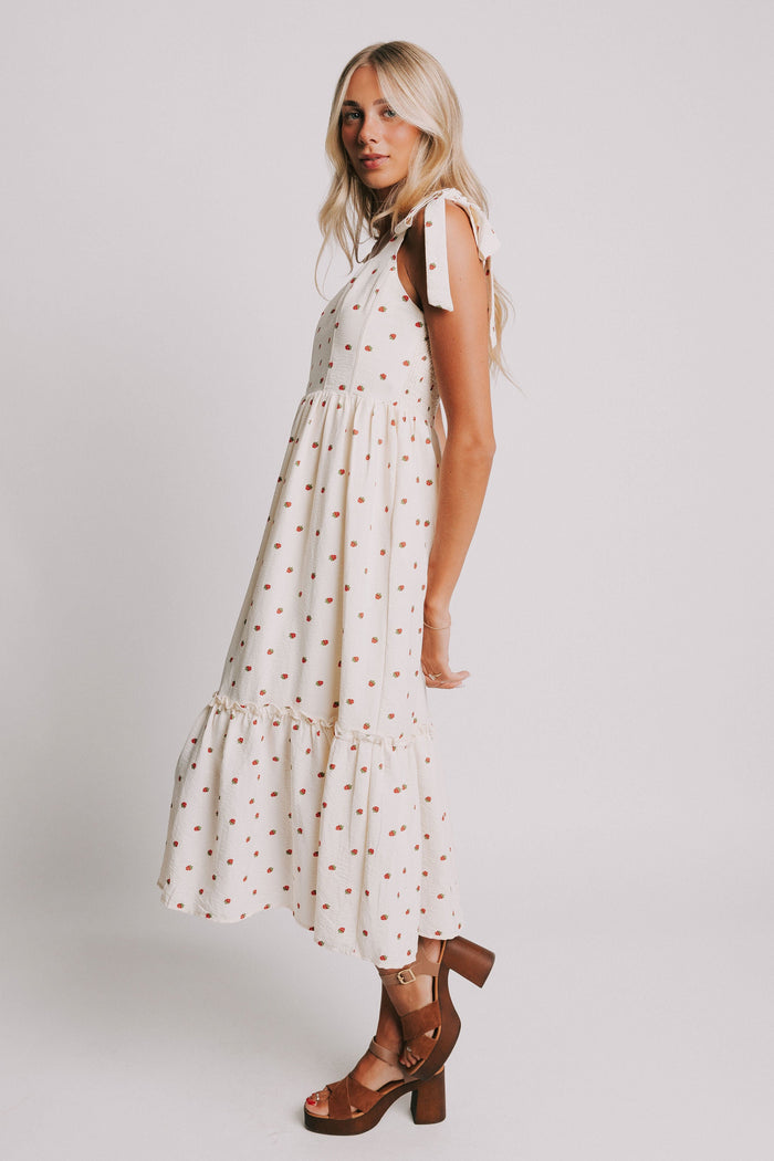cream midi dress with strawberry print and bows on shoulders side