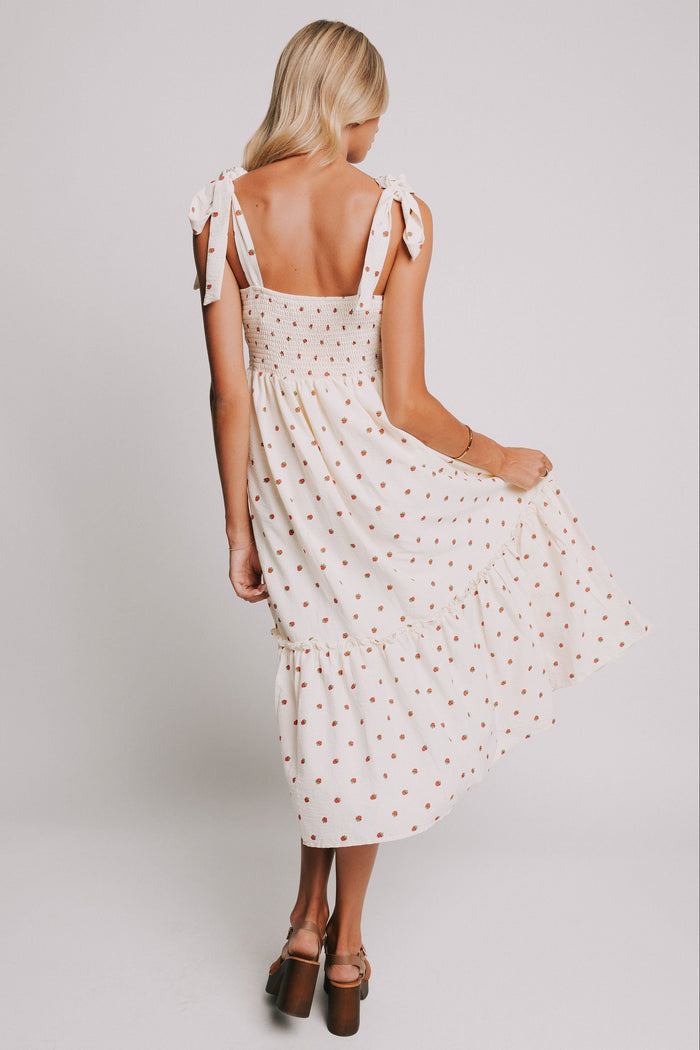 cream midi dress with strawberry print and bows on shoulders