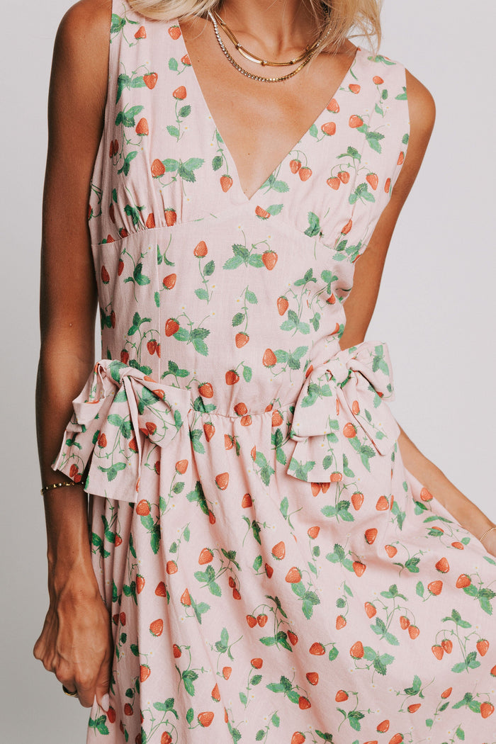 pink v neck maxi dress with strawberry print and bow details close