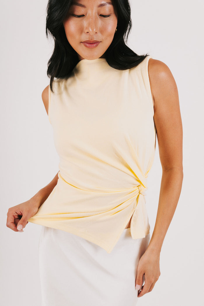 yellow sleeveless top with side twist front