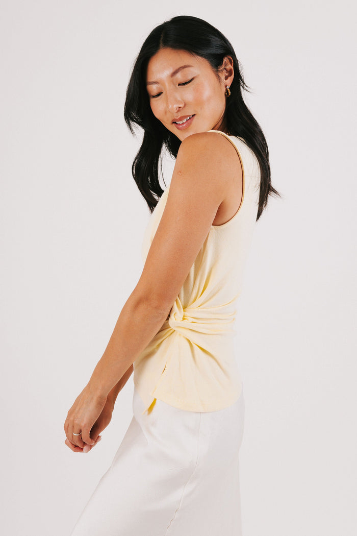 yellow sleeveless top with side twist side
