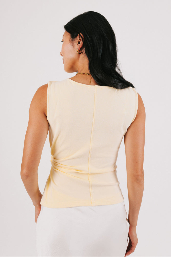 yellow sleeveless top with side twist back